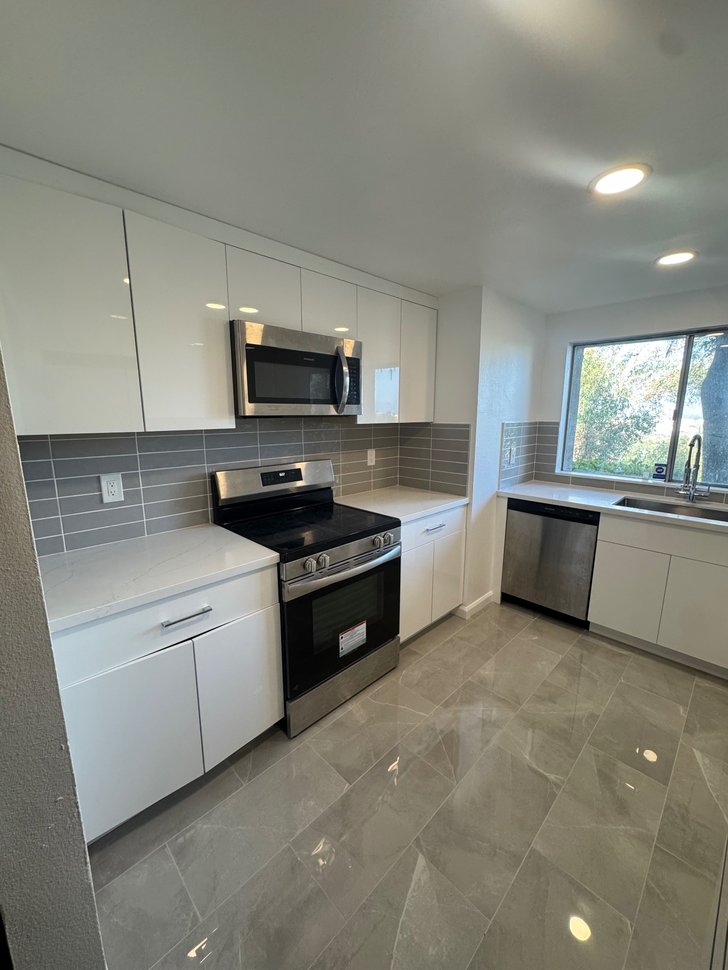 EliteBlvd modern kitchen remodel — after with white cabinets and quartz counters