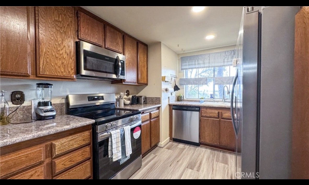 Kitchen — before remodel with dated wood cabinets